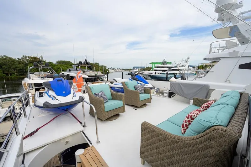 Slide: The Image of Luxurious 2001 Westport Motor Yacht Raised Pilothouse with outdoor seating and jet skis. - 13