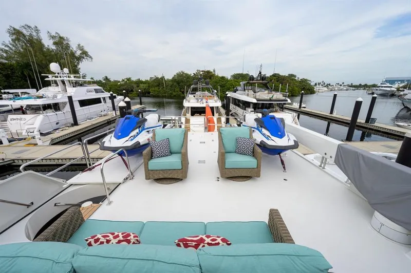Slide: The Image of 2001 Westport Motor Yacht Raised Pilothouse with jet skis and seating on deck. - 14