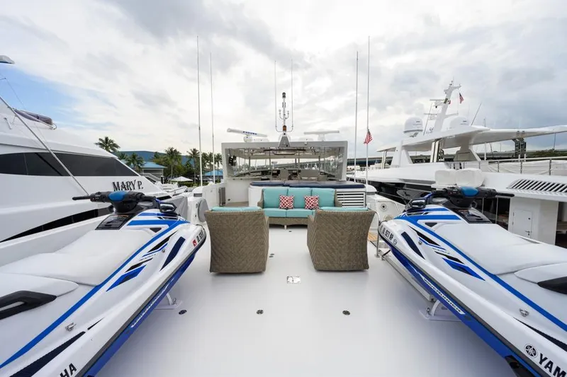 Slide: The Image of Luxurious 2001 Westport Motor Yacht with jet skis and elegant seating area. - 15