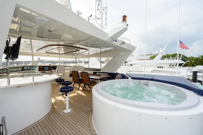 Slide: The Image of Luxurious 2001 Westport Motor Yacht with jacuzzi and elegant outdoor seating area. - 19