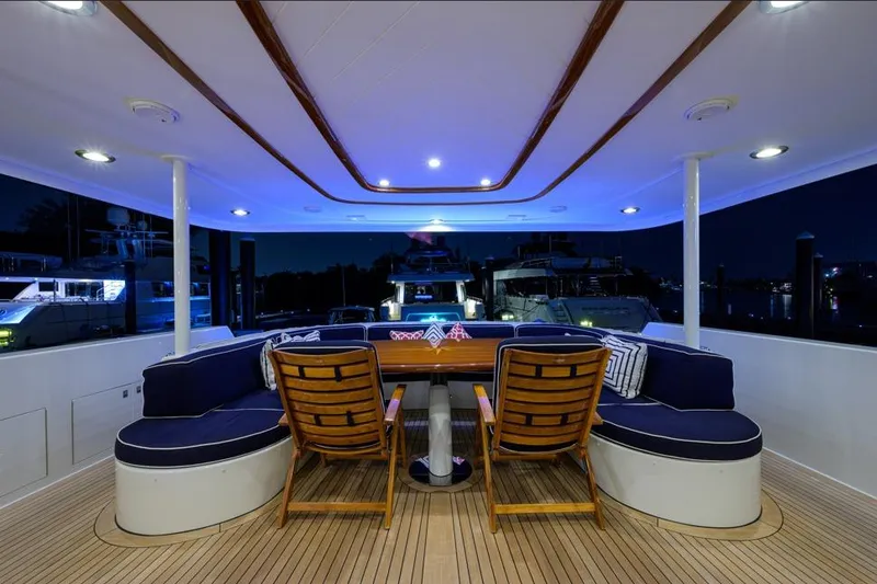 Slide: The Image of Luxurious 2001 Westport Motor Yacht Raised Pilothouse with elegant deck seating at night. - 2