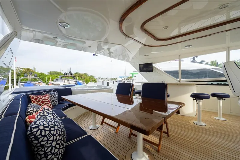 Slide: The Image of Luxurious 2001 Westport Motor Yacht Raised Pilothouse with elegant seating and polished wood table. - 21