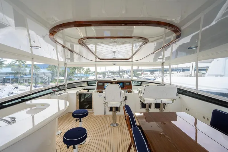 Slide: The Image of Luxurious 2001 Westport Motor Yacht Raised Pilothouse interior with helm, seating, and dining area. - 25