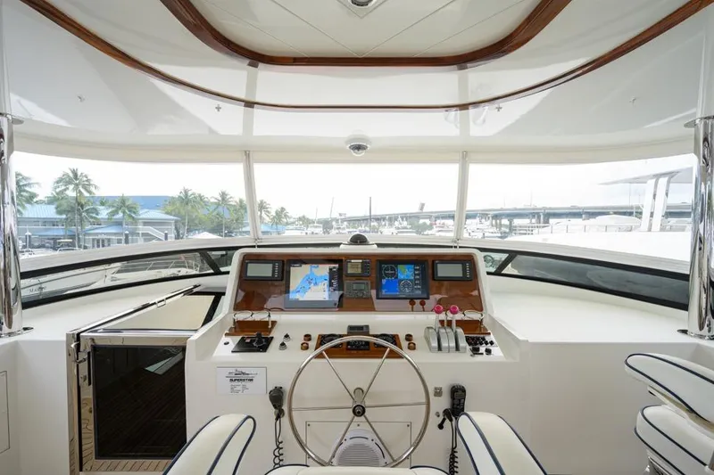 Slide: The Image of 2001 Westport Motor Yacht Raised Pilothouse helm with navigation screens and steering wheel. - 27