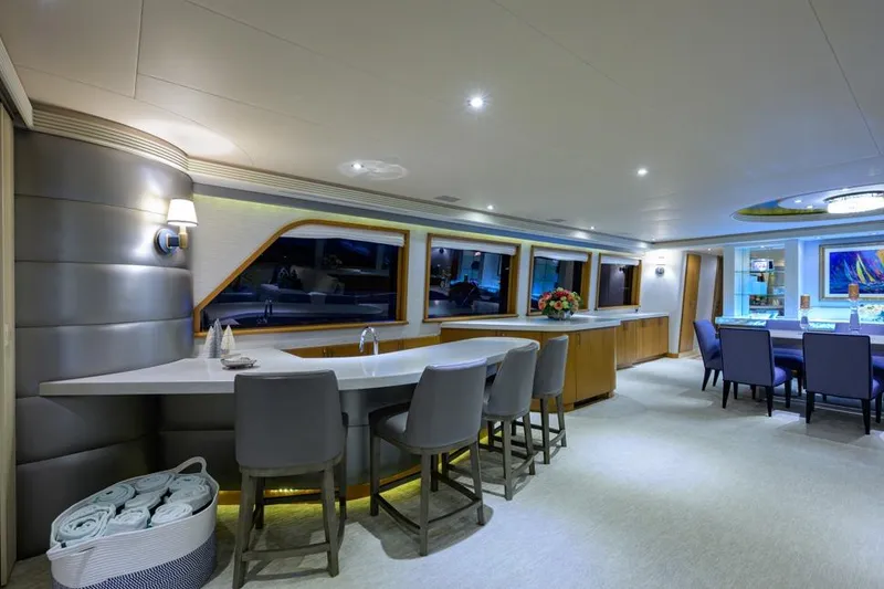 Slide: The Image of Luxurious interior of 2001 Westport Motor Yacht Raised Pilothouse with modern dining and bar area. - 32