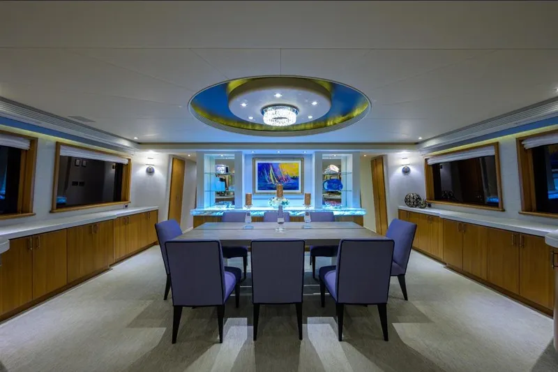 Slide: The Image of Luxurious dining area in 2001 Westport Motor Yacht Raised Pilothouse, featuring elegant decor and lighting. - 42