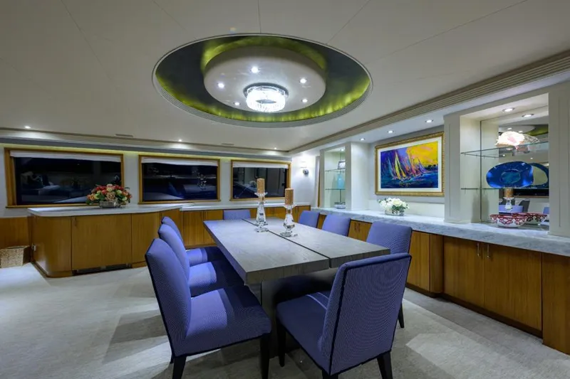 Slide: The Image of Luxurious dining area in 2001 Westport Motor Yacht Raised Pilothouse, featuring elegant decor and modern lighting. - 45