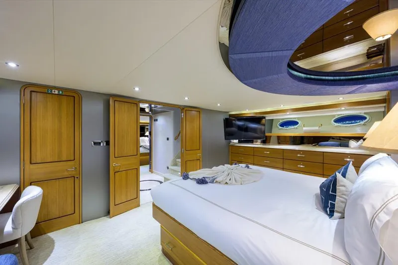 Slide: The Image of Luxurious 2001 Westport Motor Yacht bedroom with elegant wood finishes and modern amenities. - 48