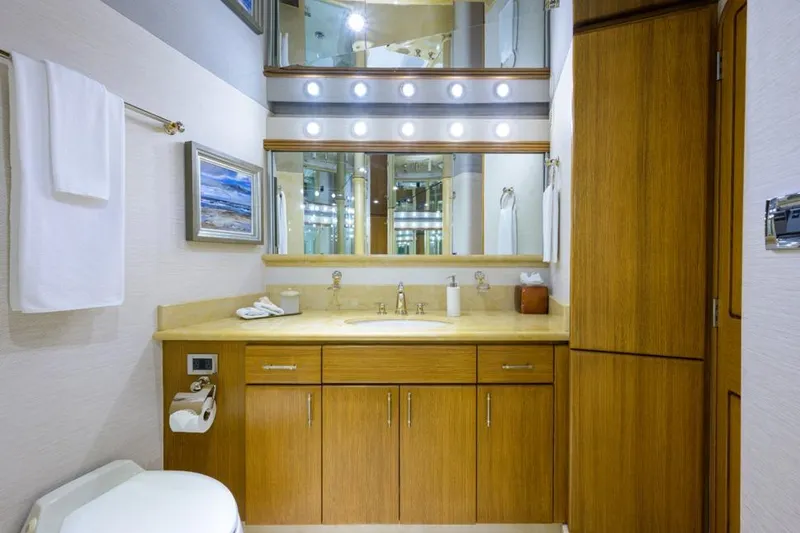 Slide: The Image of Luxurious bathroom in 2001 Westport Motor Yacht Raised Pilothouse, featuring wood cabinetry and elegant lighting. - 51