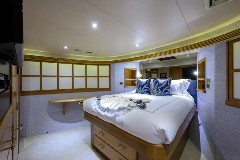 Slide: The Image of Luxurious bedroom in 2001 Westport Motor Yacht Raised Pilothouse, featuring elegant bedding and ambient lighting. - 56