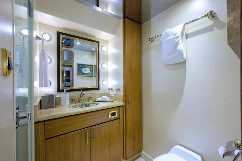 Slide: The Image of Luxurious bathroom in 2001 Westport Motor Yacht Raised Pilothouse, featuring elegant wood cabinetry. - 63