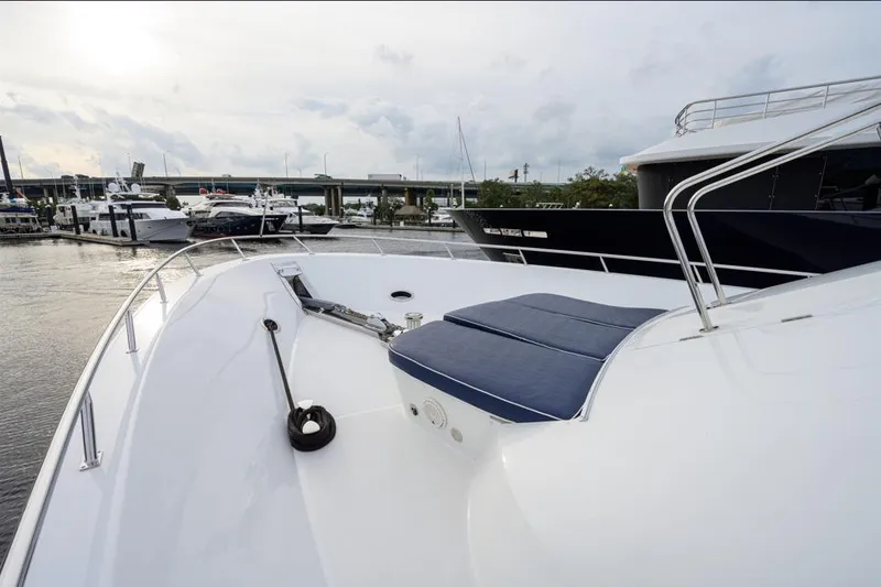Slide: The Image of 2001 Westport Motor Yacht Raised Pilothouse docked at marina, showcasing sleek deck design. - 69