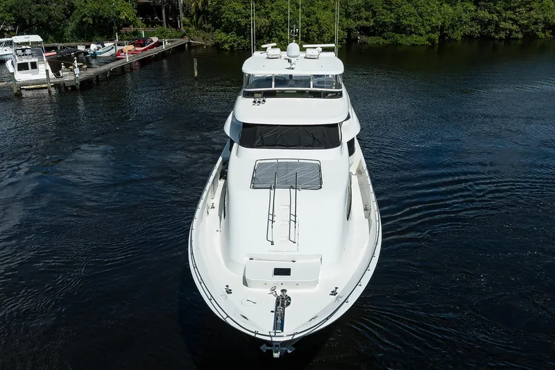 Slide: The Image of 2001 Westport Motor Yacht Raised Pilothouse on calm water, surrounded by greenery. - 70