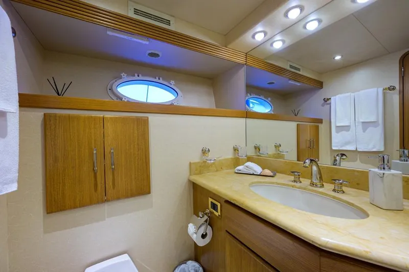 Slide: The Image of Luxurious bathroom in 2001 Westport Motor Yacht Raised Pilothouse with elegant fixtures and porthole window. - 74