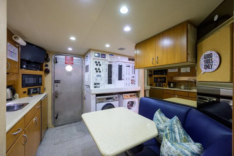 Slide: The Image of Interior of 2001 Westport Motor Yacht Raised Pilothouse with kitchen and seating area. - 75