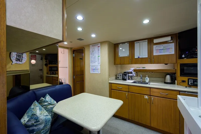 Slide: The Image of Interior of 2001 Westport Motor Yacht Raised Pilothouse with kitchen and dining area. - 77