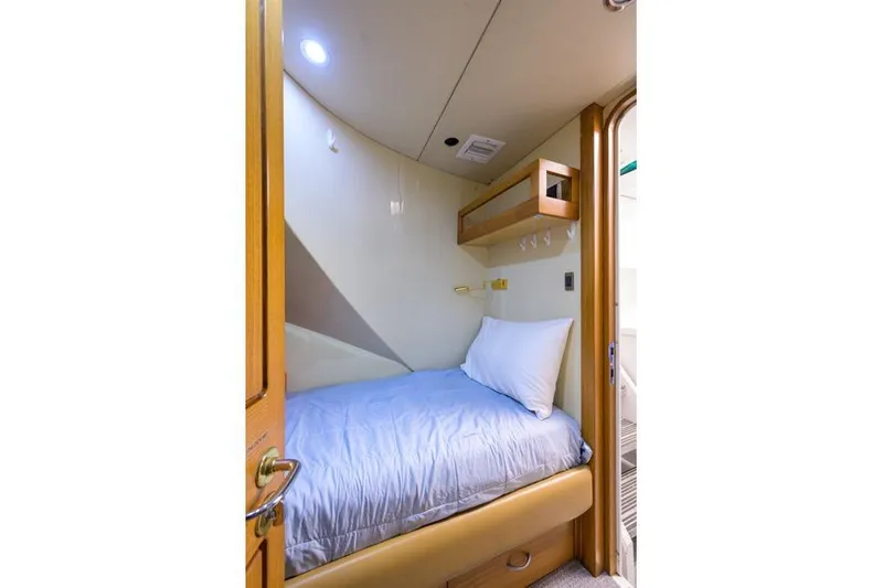 Slide: The Image of Cozy cabin interior of 2001 Westport Motor Yacht Raised Pilothouse with single bed and wooden accents. - 82