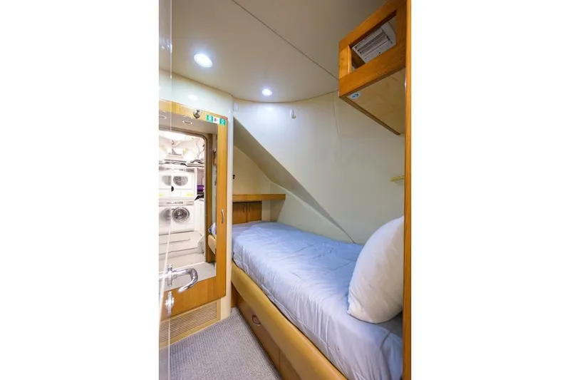 Slide: The Image of Cozy cabin interior of 2001 Westport Motor Yacht Raised Pilothouse with single bed and storage. - 83
