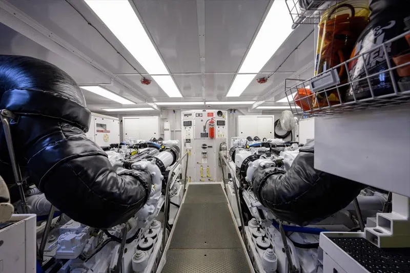 Slide: The Image of Engine room of 2001 Westport Motor Yacht Raised Pilothouse, featuring dual engines and equipment. - 86