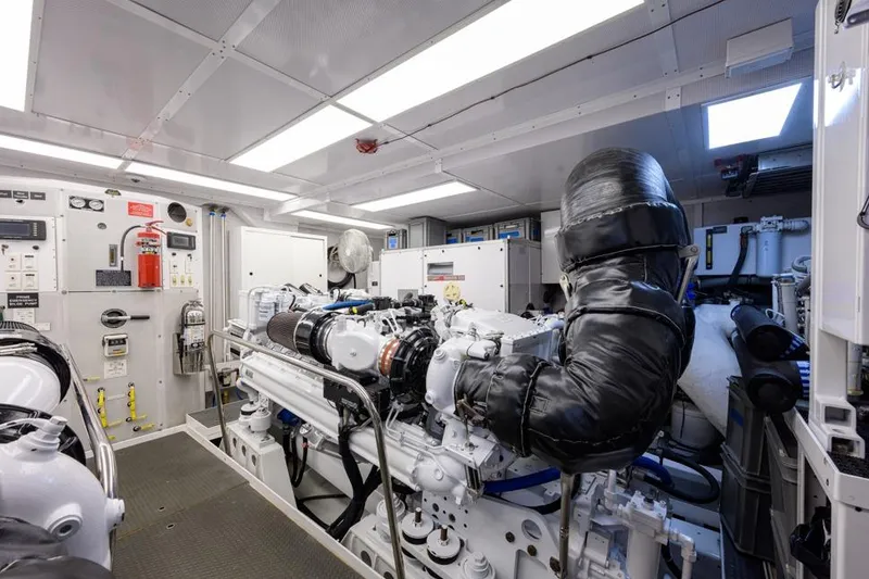 Slide: The Image of Engine room of 2001 Westport Motor Yacht Raised Pilothouse, featuring advanced machinery and controls. - 87