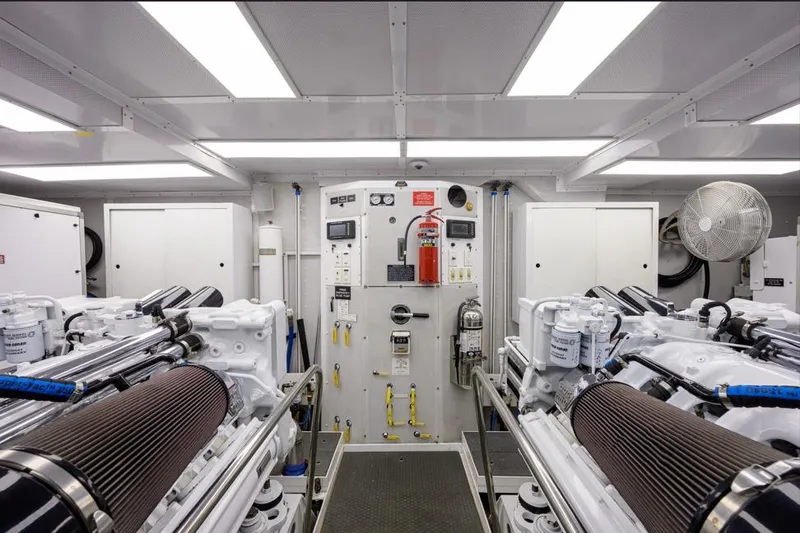 Slide: The Image of Engine room of a 2001 Westport Motor Yacht Raised Pilothouse, featuring machinery and control panels. - 89