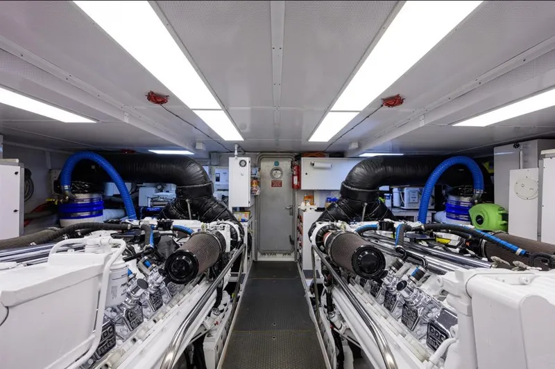 Slide: The Image of Engine room of 2001 Westport Motor Yacht Raised Pilothouse, featuring dual engines and ventilation systems. - 90