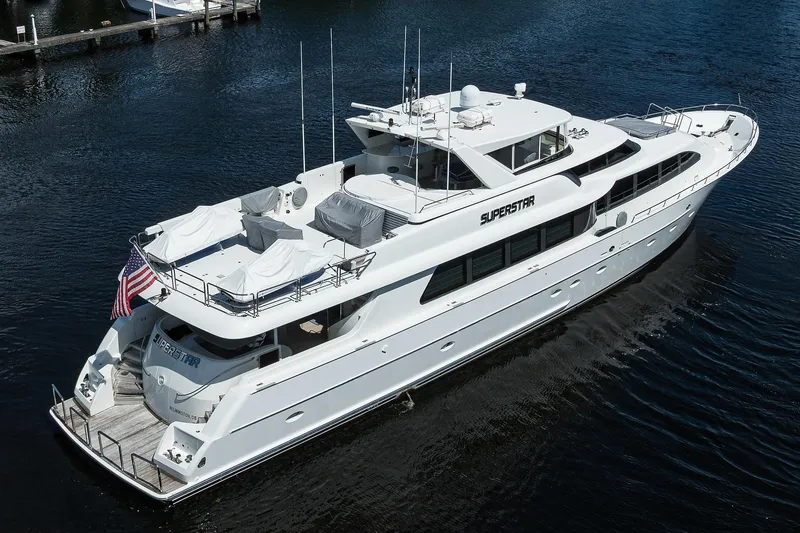Slide: The Image of 2001 Westport Motor Yacht Raised Pilothouse on water, featuring sleek design and spacious deck. - 91