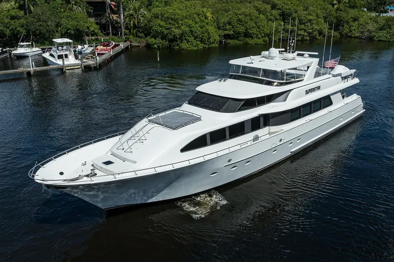 Slide: The Image of Luxurious 2001 Westport Motor Yacht Raised Pilothouse cruising on a serene waterway. - 94