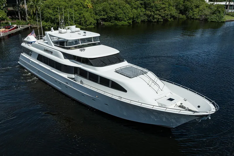 Slide: The Image of Luxurious 2001 Westport Motor Yacht Raised Pilothouse cruising on a serene waterway. - 95