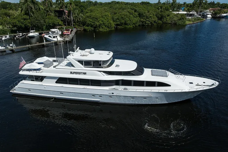 Slide: The Image of 2001 Westport Motor Yacht Raised Pilothouse cruising on a serene waterway. - 96