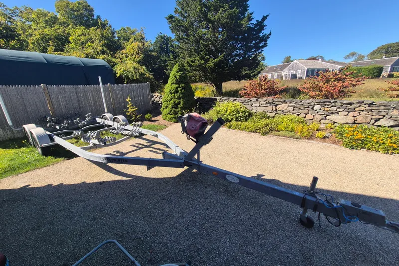 Slide: The Image of Boat trailer for 2015 Robalo R242 Center Console in a sunny driveway. - 14