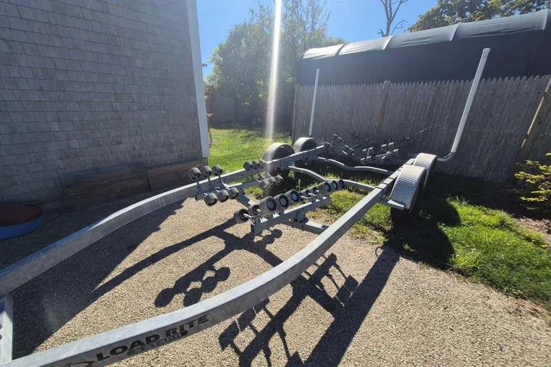 Slide: The Image of Trailer for 2015 Robalo R242 Center Console boat, parked outdoors in sunlight. - 16