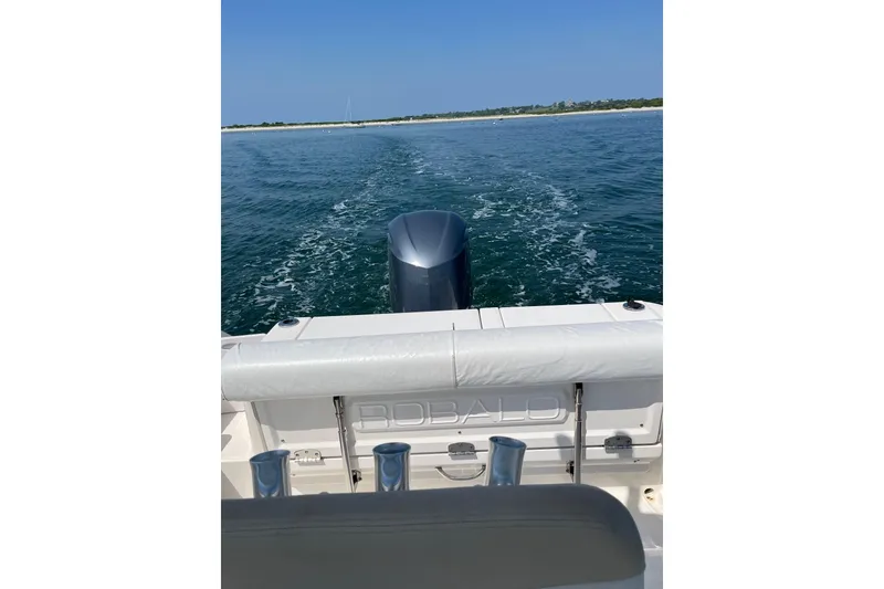 Slide: The Image of 2015 Robalo R242 Center Console boat cruising on open water. - 21