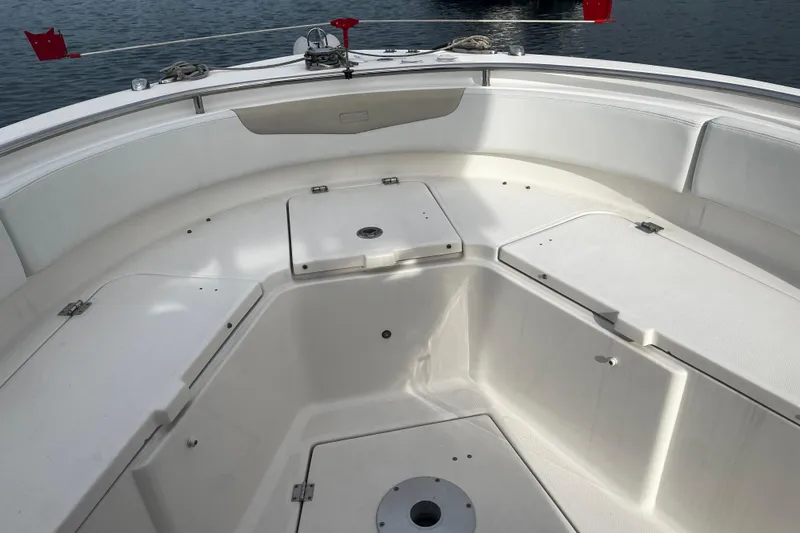 Slide: The Image of 2015 Robalo R242 Center Console boat interior with storage compartments and seating. - 22