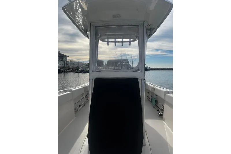 Slide: The Image of 2015 Robalo R242 Center Console boat docked with clear sky background. - 24