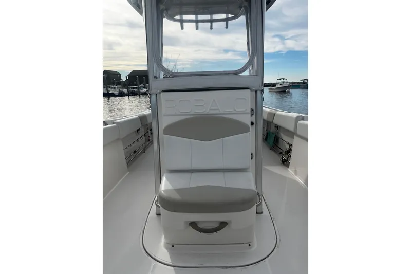 Slide: The Image of 2015 Robalo R242 Center Console boat interior with seating, docked at marina. - 27