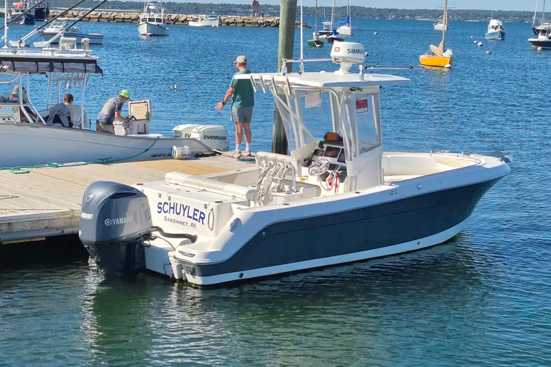Slide: The Image of 2015 Robalo R242 Center Console boat docked in a marina. - 3