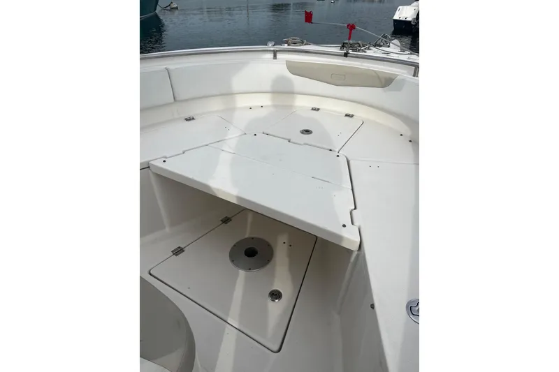 Slide: The Image of 2015 Robalo R242 Center Console boat interior with seating and storage compartments. - 31