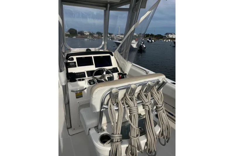 Slide: The Image of 2015 Robalo R242 Center Console boat interior with steering wheel and ropes. - 37