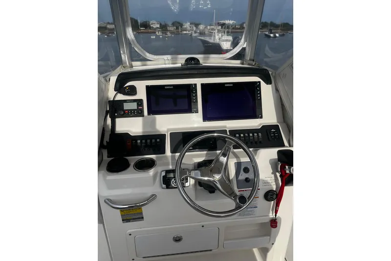 Slide: The Image of 2015 Robalo R242 Center Console helm with navigation screens and controls. - 39