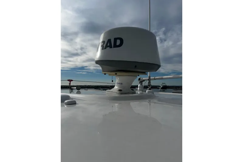 Slide: The Image of Radar equipment on 2015 Robalo R242 Center Console boat under cloudy sky. - 40