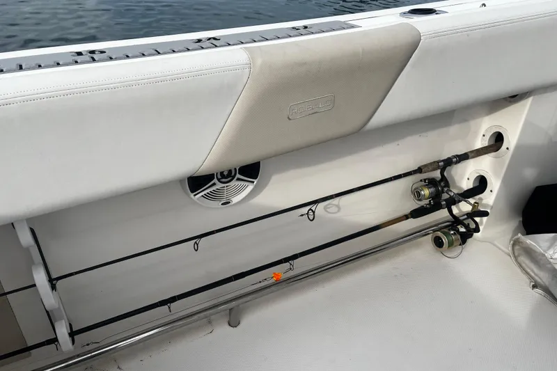 Slide: The Image of 2015 Robalo R242 Center Console boat with fishing rod holders and speaker. - 44