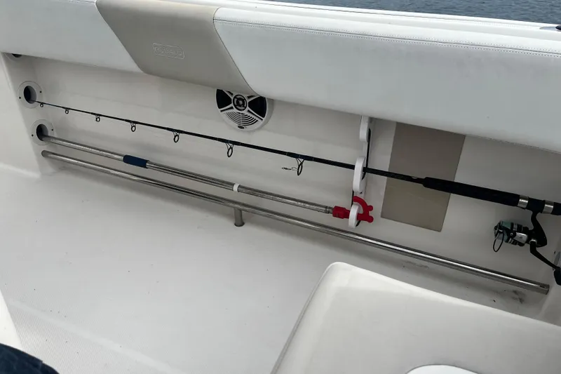 Slide: The Image of 2015 Robalo R242 Center Console fishing rod storage with speaker detail. - 45