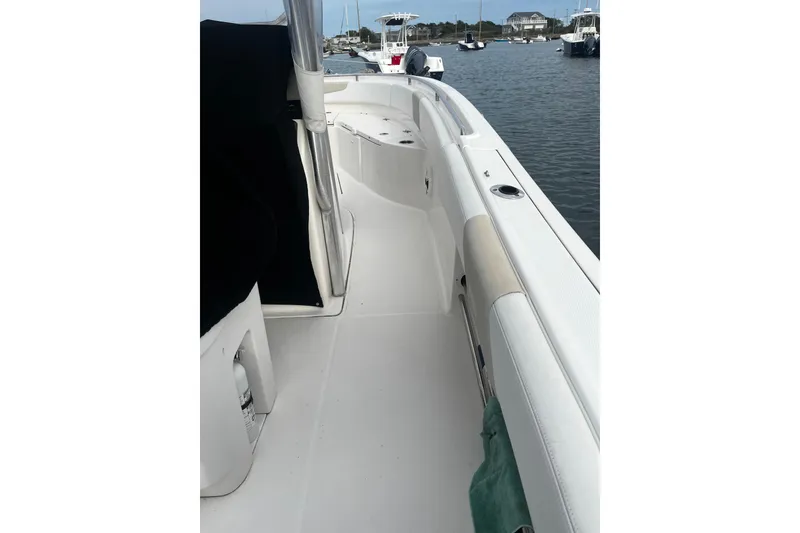 Slide: The Image of 2015 Robalo R242 Center Console boat interior, docked in a marina. - 50