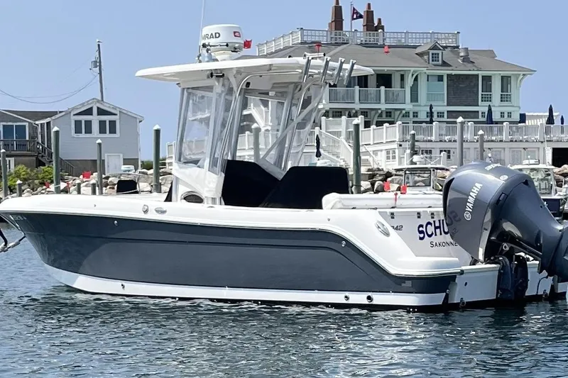Slide: The Image of 2015 Robalo R242 Center Console boat docked near waterfront homes. - 51