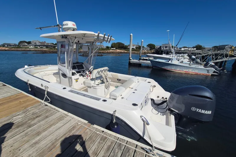 Slide: The Image of 2015 Robalo R242 Center Console boat docked with Yamaha engine, clear blue sky. - 53