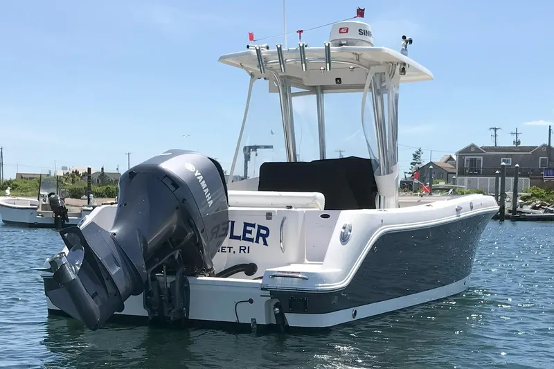 Slide: The Image of 2015 Robalo R242 Center Console boat with Yamaha engine on water. - 54