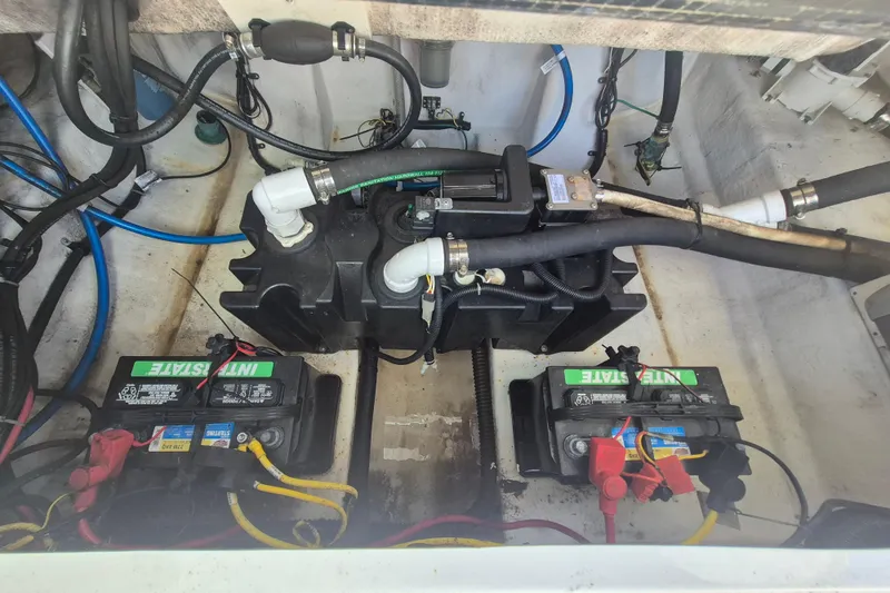Slide: The Image of 2015 Robalo R242 Center Console boat battery compartment with wiring and components. - 9