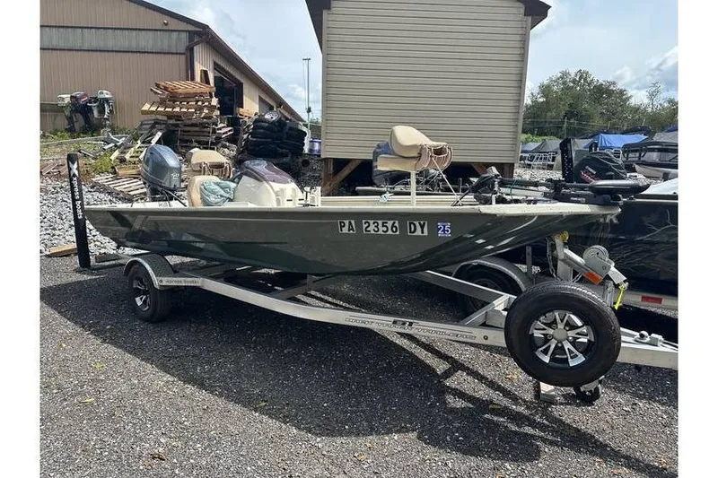 The Image of 2020 Xpress XP170 boat on trailer, parked outdoors near a storage building. - 1