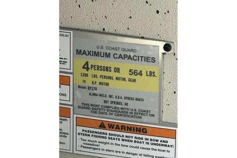 Slide: The Image of Boat capacity label for Xpress XP170, 2020 model, showing maximum 4 persons or 564 lbs. - 10